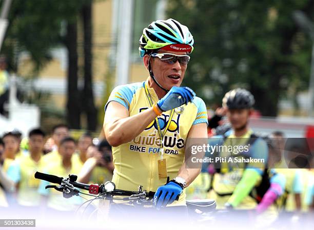 Thailand's Crown Prince Maha Vajiralongkorn waves to the crowd as he cycles in the "Bike for Dad" event in Bangkok. Thai Crown Prince Maha...