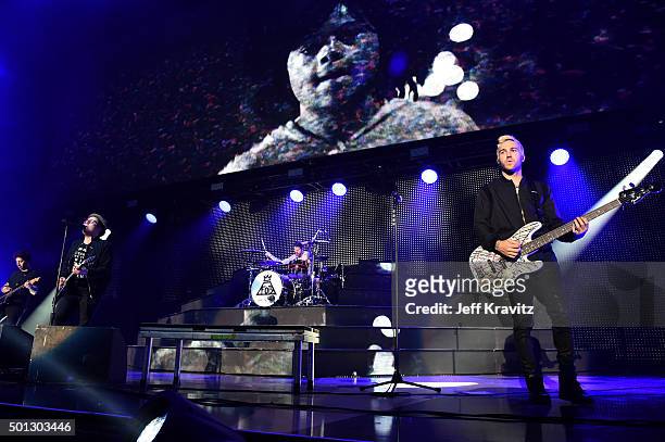 Musicians Joe Trohman, Patrick Stump, Andy Hurley and Pete Wentz of Fall Out Boy perform at The Forum on December 13, 2015 in Inglewood, California.