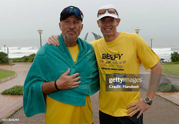 In this handout image provided by Philip Brown, Sir Ian Botham and Shaun Pollock pose after the 'Beefy Walking the Rainbow Nation' charity walk on...