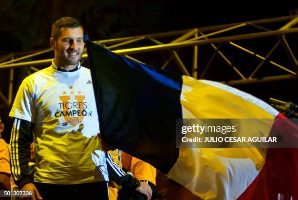 Andre Pierre Gignac, forward of Tigres waves a French flag during the celebration after winning their Mexican Apertura 2015 tournament football final...