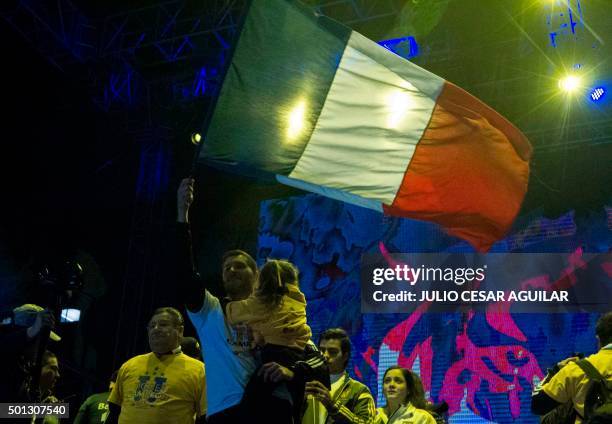 Andre Pierre Gignac, forward of Tigres waves a French flag during the celebration after winning their Mexican Apertura 2015 tournament football final...