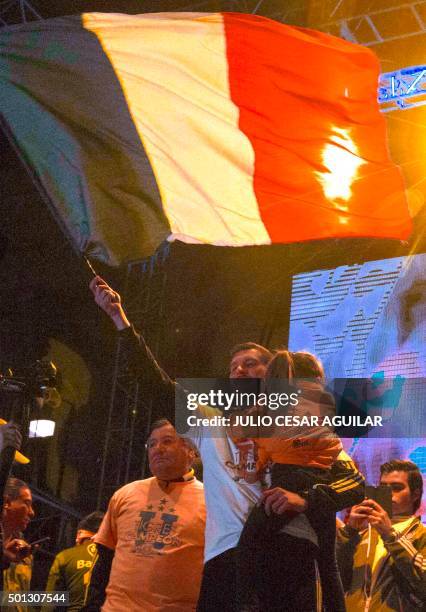 Andre Pierre Gignac, forward of Tigres waves a French flag during the celebration after winning their Mexican Apertura 2015 tournament football final...