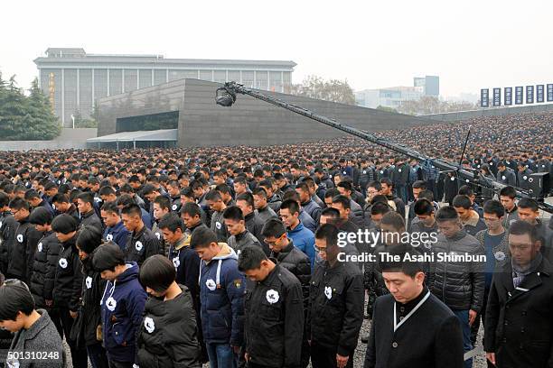 People observe a minute of silence during the state ceremony for victims of Nanjing Massacre on China's second National Memorial Day on December 13,...