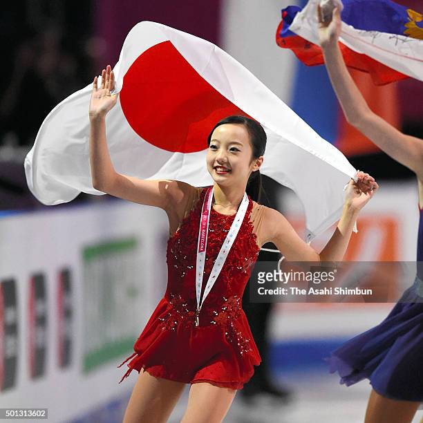 Bronze medalist Marin Honda of Japan applauds fans after the medal ceremony for the Junior Ladies Singles during day three of the ISU Grand Prix of...
