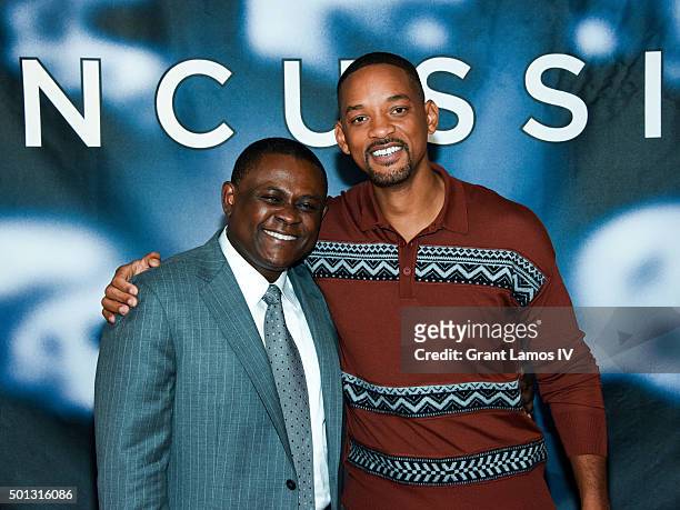 Dr. Bennet Omalu and Will Smith attend the "Concussion" Cast Photo Call at Crosby Street Hotel on December 14, 2015 in New York City.