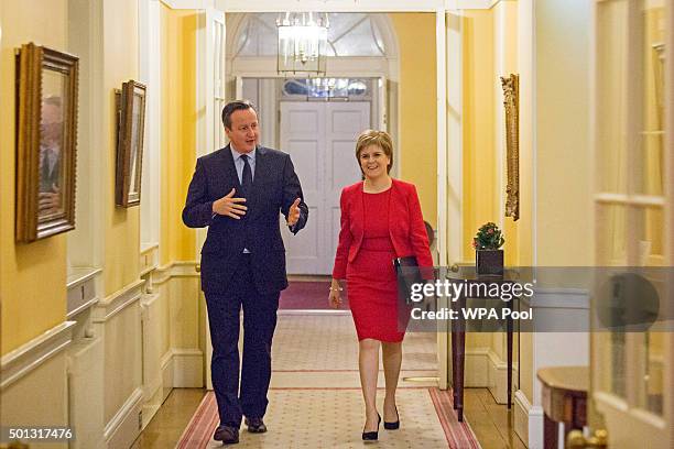 British Prime Minister David Cameron walks with Scottish First Minister Nicola Sturgeon as she arrives for talks at 10 Downing Street on December 14,...