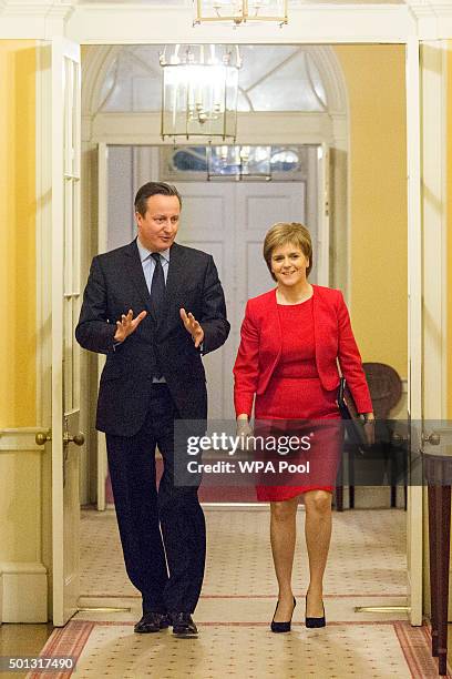 British Prime Minister David Cameron walks with Scottish First Minister Nicola Sturgeon as she arrives for talks at 10 Downing Street on December 14,...