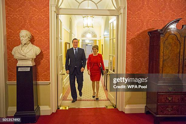 British Prime Minister David Cameron walks with Scottish First Minister Nicola Sturgeon as she arrives for talks at 10 Downing Street on December 14,...