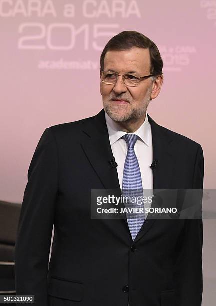 Spanish Prime Minister and Popular Party leader and candidate in the December 20 general elections, Mariano Rajoy looks on as he poses before a face...