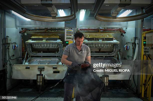 Copo Galicia employee works on a seat cover in Mos, northwestern Spain on December 9, 2015. Amid the Spanish economic crisis, some sectors, such as...