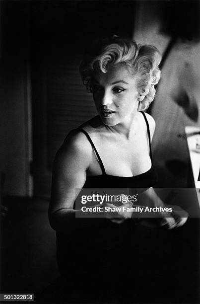 Marilyn Monroe at a makeup table getting ready for an event in 1955 in New York, New York.