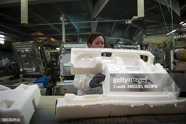 Copo Galicia employee works on a car seat production line in Mos, northwestern Spain on December 9, 2015. Amid the Spanish economic crisis, some...