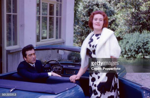 Australian soprano opera singer Joan Sutherland pictured with her husband, conductor Richard Bonynge sitting in a car outside their home in 1962.