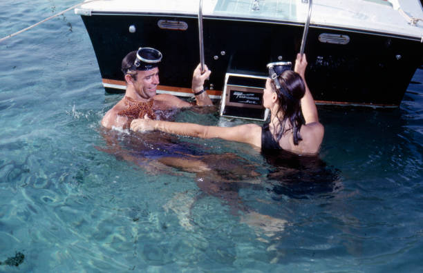 Scottish actor Sean Connery as 'James Bond' pictured with French actress Claudine Auger as 'Domino Derval' in water at the rear of a speed boat in a...