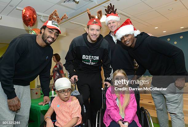 Boston Celtics James Young, David Lee, assistant coach Jay Larranaga, and Terry Rozier visit with Isabella and Arianna at Boston Children's Hospital...