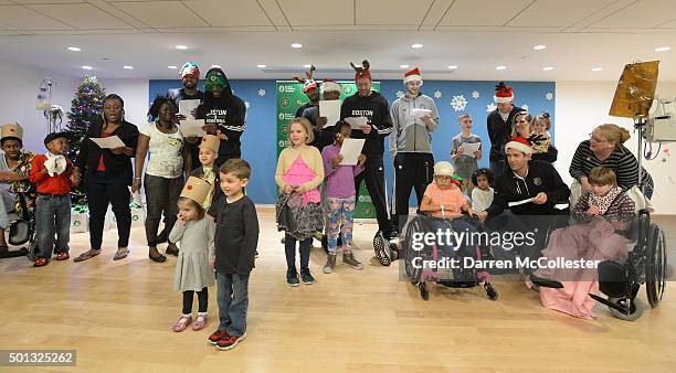 Boston Celtics Amir Johnson, Jae Crowder, James Young, Terry Rozier, David Lee, Tyler Zeller, assistant coach Jay Larranaga, and head coach Brad...