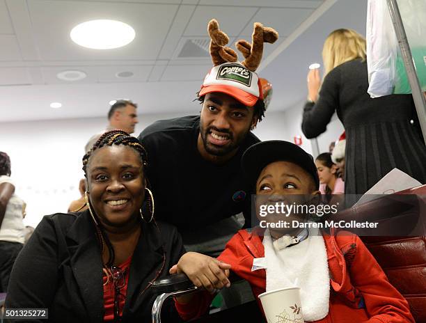 Boston Celtic James Young visits with Tony and Mom at Boston Children's Hospital December 14, 2015 in Boston, Massachusetts.