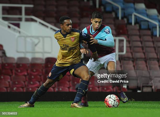 Tyrell Robinson of Arsenal is challenged by Kyle Knoyle of West Ham during match between West Ham United U21 and Arsenal U21 at Boleyn Ground on...