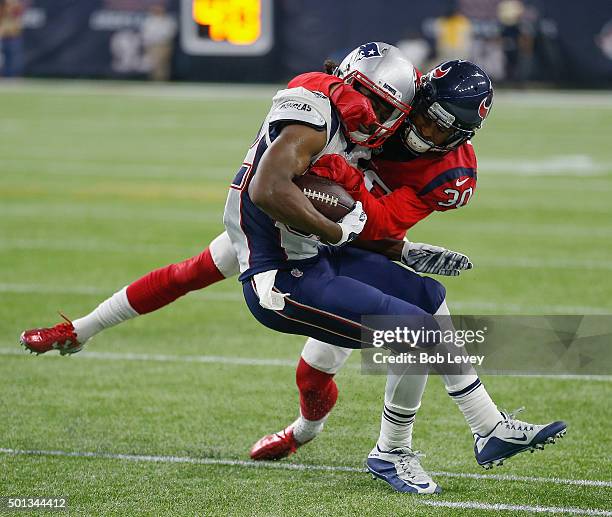 Keshawn Martin of the New England Patriots breaks a tackle attempt by Kevin Johnson of the Houston Texans at NRG Stadium on December 13, 2015 in...