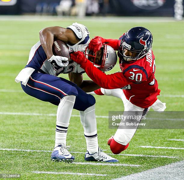 Keshawn Martin of the New England Patriots breaks a tackle attempt by Kevin Johnson of the Houston Texans at NRG Stadium on December 13, 2015 in...