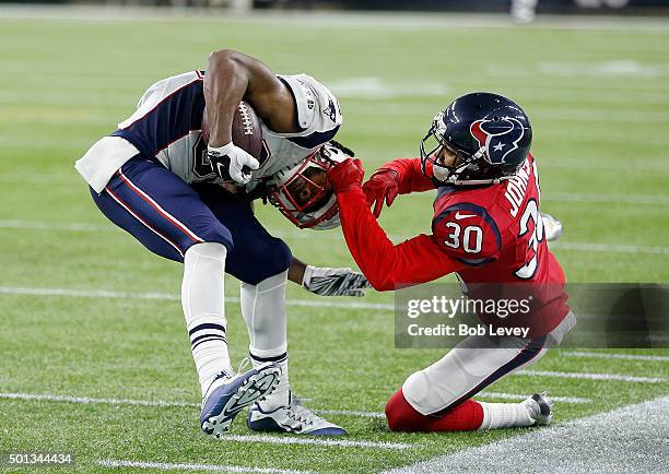 Keshawn Martin of the New England Patriots breaks a tackle attempt by Kevin Johnson of the Houston Texans at NRG Stadium on December 13, 2015 in...