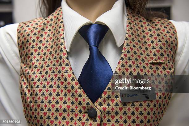 Name badge is displayed on Min, a prototype human-like electronic croupier, during a demonstration at the headquarters of Paradise Entertainment Ltd....