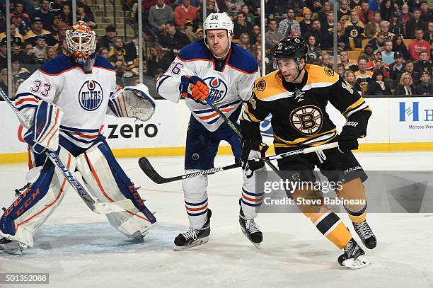 Brett Connolly of the Boston Bruins watches the play against Cam Talbot and Nikita Nikitin of the Edmonton Oliers at the TD Garden on December 14,...