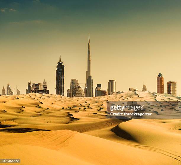 skyline von dubai aus der wüste - dubai stock-fotos und bilder