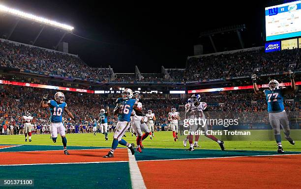 Lamar Miller of the Miami Dolphins scores a touchdown during the first quarter of the game against the New York Giants at Sun Life Stadium on...