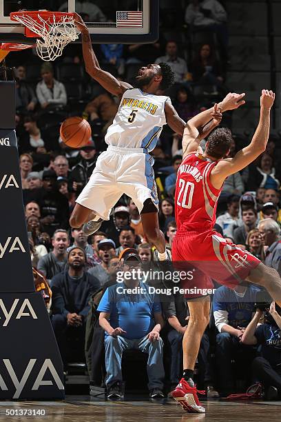 Will Barton of the Denver Nuggets dunks the ball and is fouled by Donatas Motiejunas of the Houston Rockets at Pepsi Center on December 14, 2015 in...