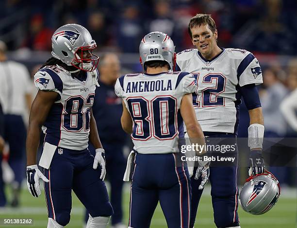 Tom Brady of the New England Patriots talks with Danny Amendola and Keshawn Martin at NRG Stadium on December 13, 2015 in Houston, Texas.