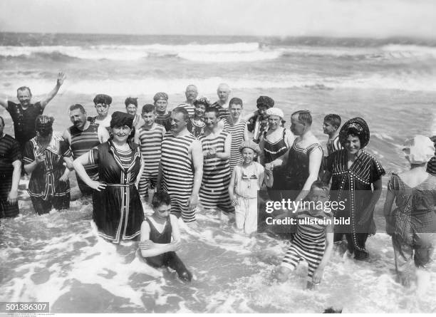 Norderney island, North Sea: people standing in the water - 1910