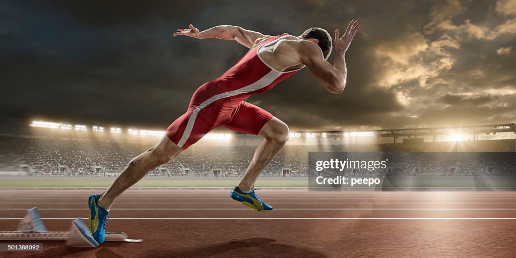 Male Sprinter Sprint Starts From Blocks in Athletics Stadium