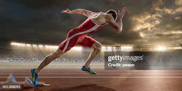 Male Sprinter Sprint Starts From Blocks in Athletics Stadium Male Sprinter Sprint Starts From Blocks in Athletics Stadium
