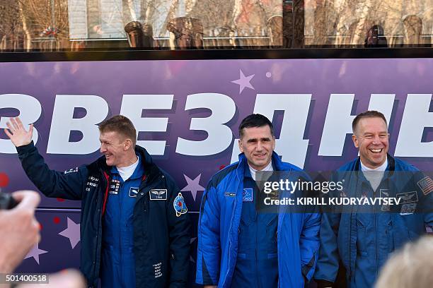 Britain's astronaut Tim Peake, Russian cosmonaut Yuri Malenchenko and US astronaut Tim Kopra pose for pictures near a bus during a sending-off...