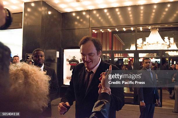 Director Quentin Tarantino signs autographs for fans gathered around the theater entrance before the premiere of "Hateful Eight." At the premiere of...