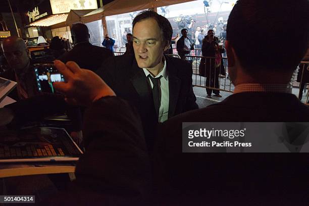 Director Quentin Tarantino signs autographs for activists gathered opposite the theater upon his arrival at the premiere of "Hateful Eight." At the...