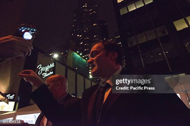 Director Quentin Tarantino signs autographs for activists gathered opposite the theater upon his arrival at the premiere of "Hateful Eight." At the...