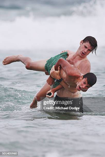 Billy Gowers of the Blues picks up Tom Silvagni, younger brother of Jack Silvagni, during a recovery session a the beach during the Carlton Blues AFL...