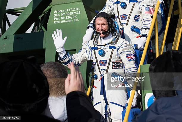 In this handout image supplied by the European Space Agency , Expedition 46 Soyuz Flight Engineer Tim Peake of ESA waves farewell prior to boarding...