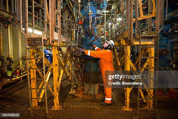 Worker inspects piping on the well deck of the Armada gas condensate platform, operated by BG Group Plc, in the North Sea, off the coast of Aberdeen,...