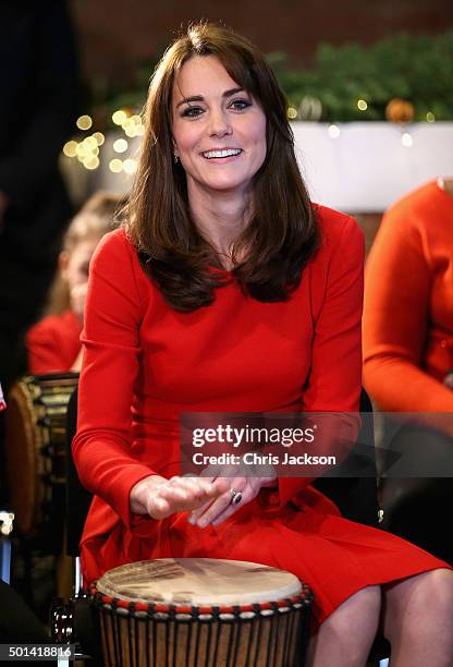 Catherine, Duchess of Cambridge takes part in some drumming 'music therapy' as she attends the Anna Freud Centre Family School Christmas Party at...