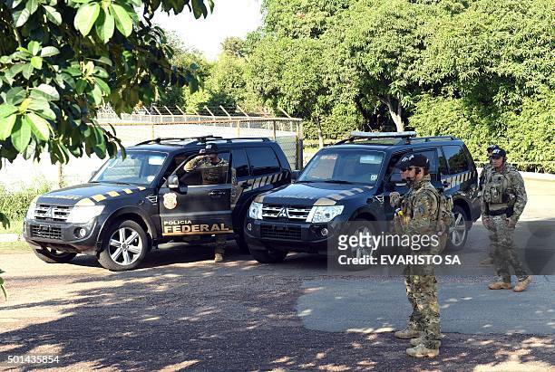 Federal Police personnel stand by during a raid on the offices of the president of the Brazilian chamber of deputies Eduardo Cunha in Brasilia, on...