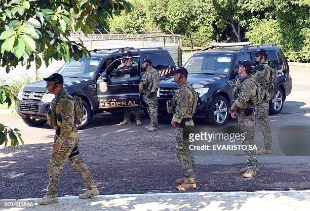 Federal Police personnel stand by during a raid on the offices of the president of the Brazilian chamber of deputies Eduardo Cunha in Brasilia, on...