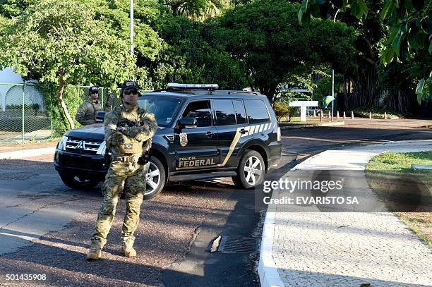 Federal Police personnel stand by during a raid on the offices of the president of the Brazilian chamber of deputies Eduardo Cunha in Brasilia, on...