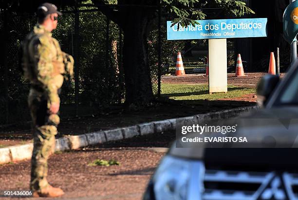 Federal Police personnel stand by during a raid on the offices of the president of the Brazilian chamber of deputies Eduardo Cunha in Brasilia, on...