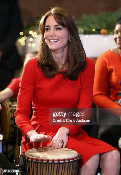 Catherine, Duchess of Cambridge takes part in some drumming 'music therapy' as she attends the Anna Freud Centre Family School Christmas Party at...