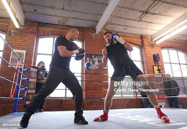 Boxer Andy Lee and trainer Adam Booth during a media work-out at Arnie's Gym on December 15, 2015 in Manchester, England. Lee defends his World...