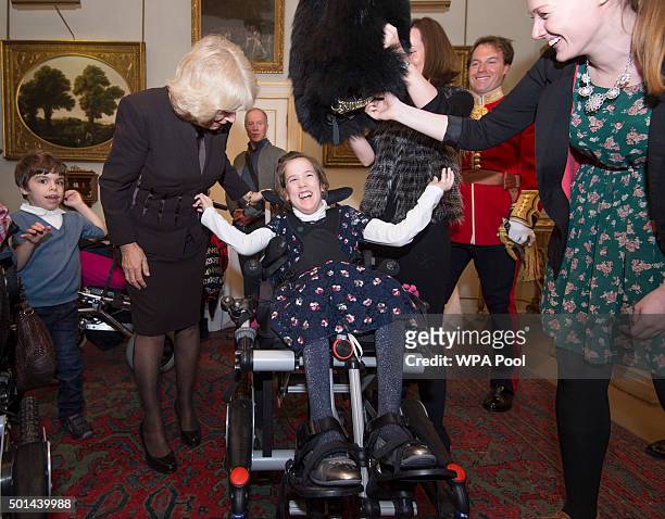 Alice Melville-Ross 12 trys on a Guards bearskin hat as Camilla, Duchess of Cornwall, patron of the Helen & Douglas House and The London Taxidrivers'...