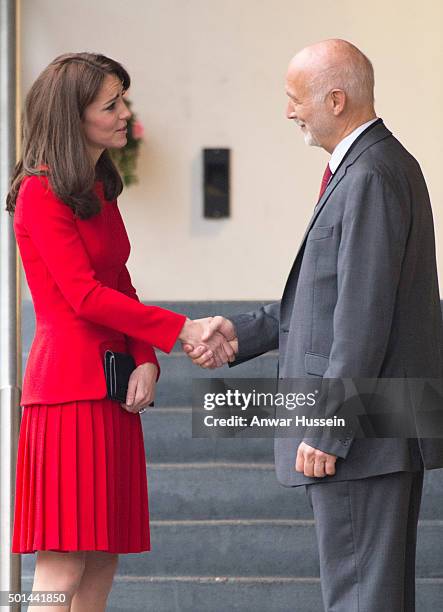 Catherine, Duchess of Cambridge, wearing a red Alexander McQueen dress, attends the Anna Freud Centre Family School Christmas Party at the Anna Freud...